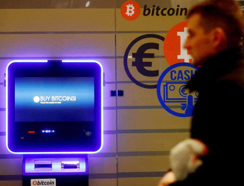 A man walks past a bitcoin ATM in Vilnius