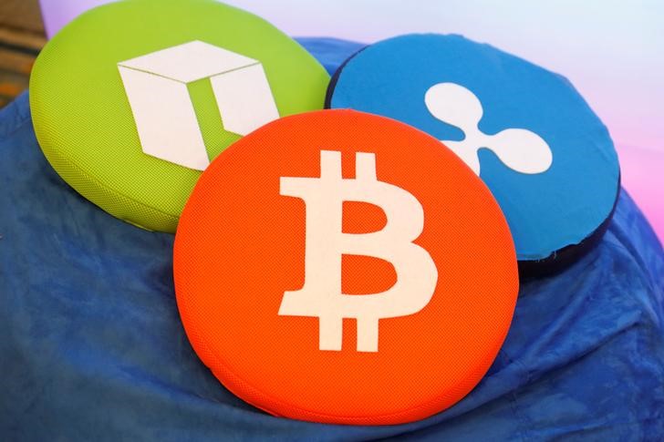 The Bitcoin logo is seen on a pillow on display at the Consensus 2018 blockchain technology conference in New York City
