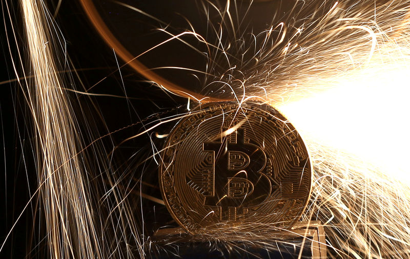 FILE PHOTO: Sparks glow from broken Bitcoin (virtual currency) coins in this illustration picture